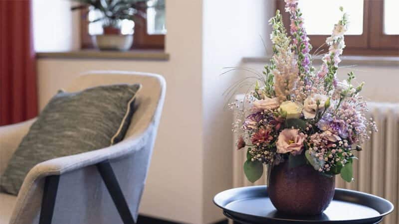 Chair and flowers in NEOVIVA hotel room